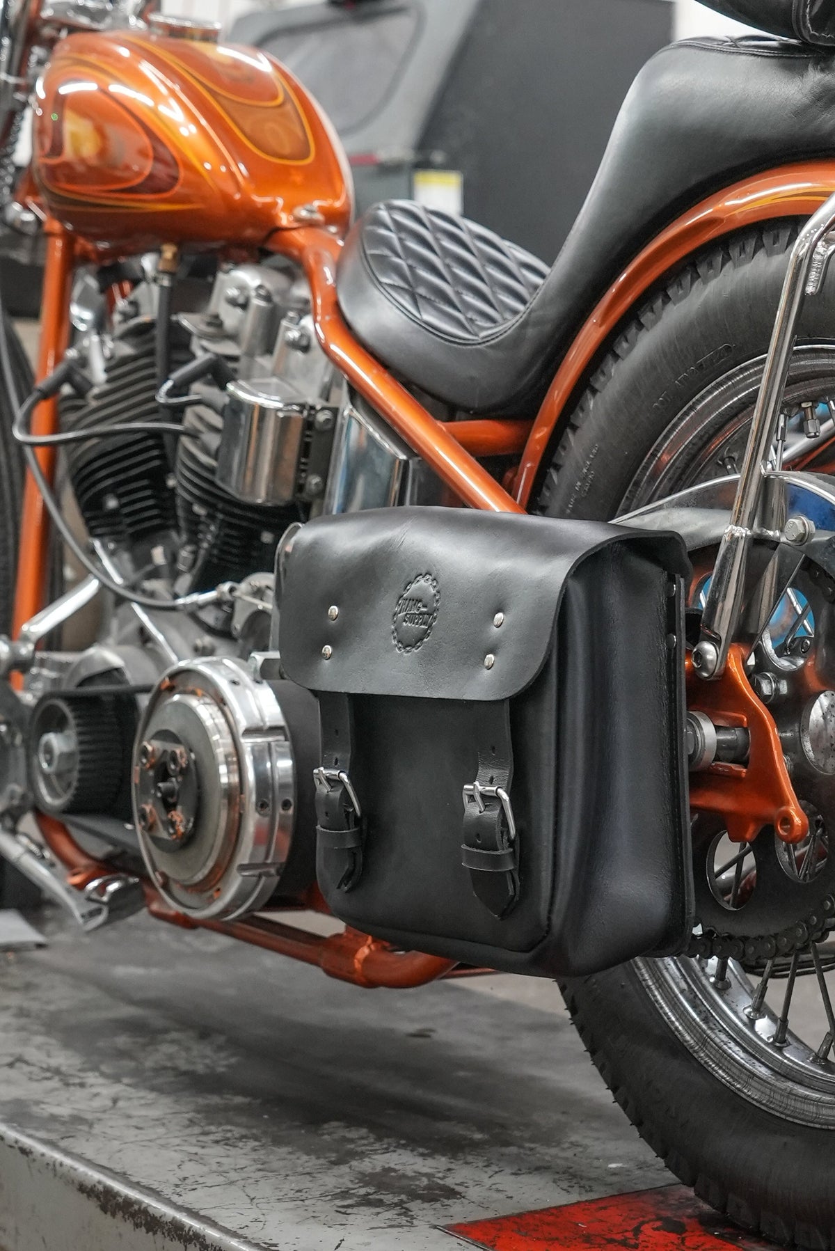 Hawg Leathers Side Mount Frame Bag in leather with hard molded back panel and embossed logo attached to rigid bike frame