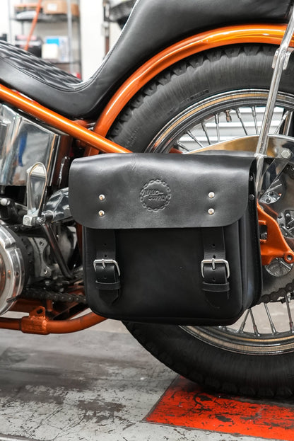 Hawg Leathers Side Mount Frame Bag made of genuine leather with hard molded back panel and embossed logo mounted on a rigid bike frame